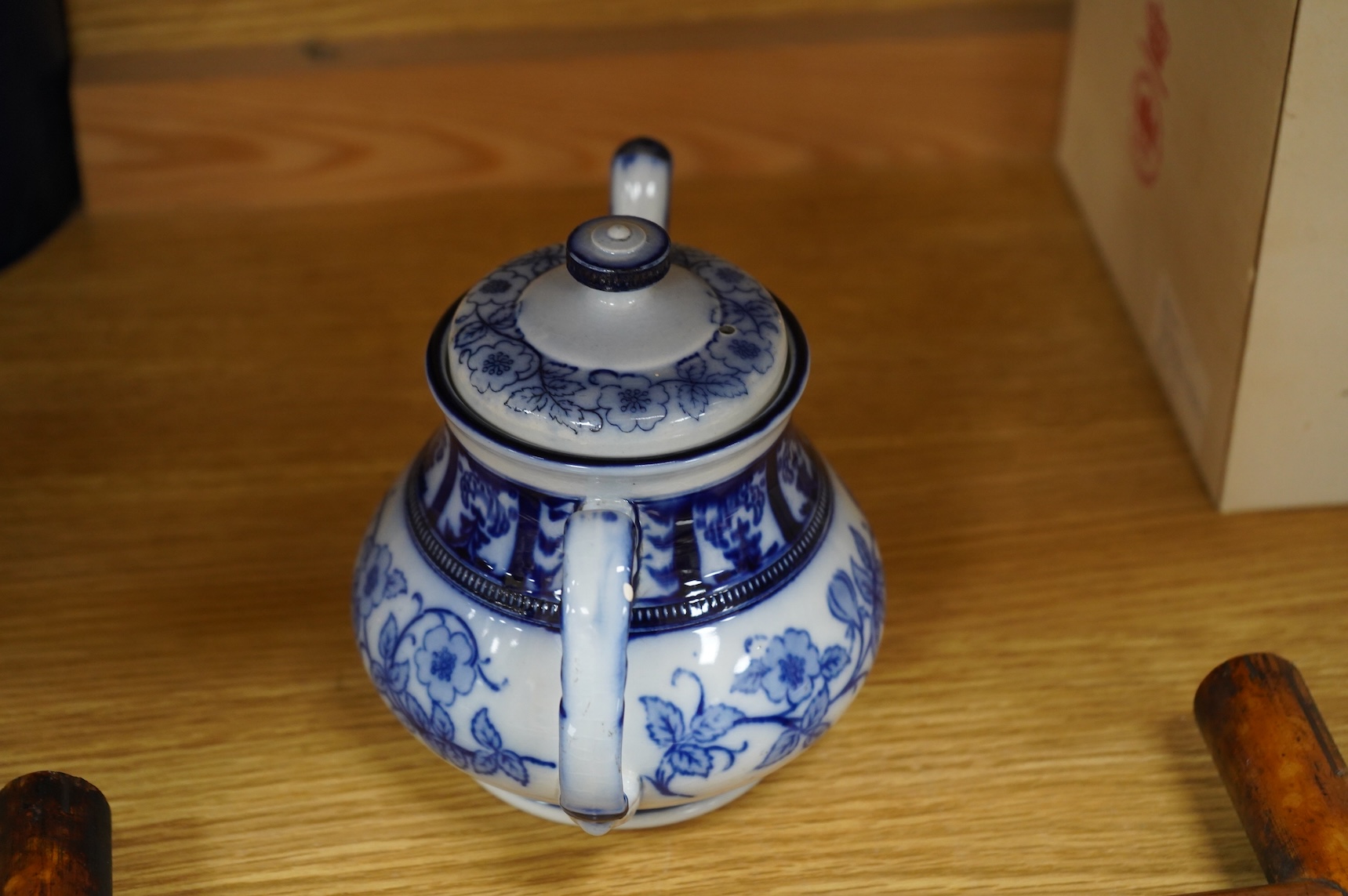 A MacIntyre Burslem blue and white teapot, c.1900, 15cm high and an early 20th century Chinese portrait photograph in a bamboo frame